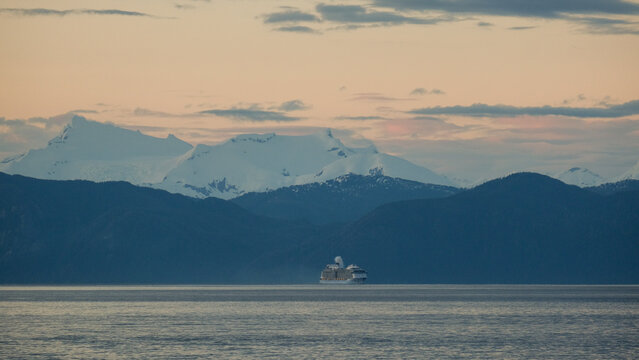 Breathtaking Alaska mountain glacier range view seen with cruise ship cruiseship liner Anthem Ovation Quantum sailing the Inside Passage transit with spectacular landscape scenery during sunset