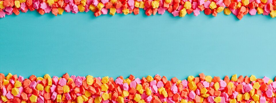 Bright confetti frames a soft teal background