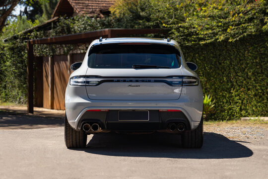 Grey Porsche Macan Luxury SUV Rear View Parked on Sunny Country House Driveway