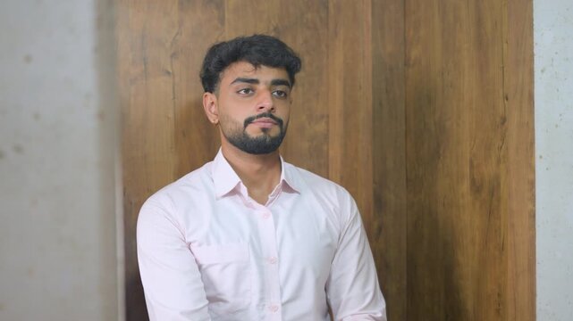 Young professional preparing for work by adjusting his shirt and wristwatch. Smooth camera movement adds a cinematic feel, suitable for office preparation and professional appearance.