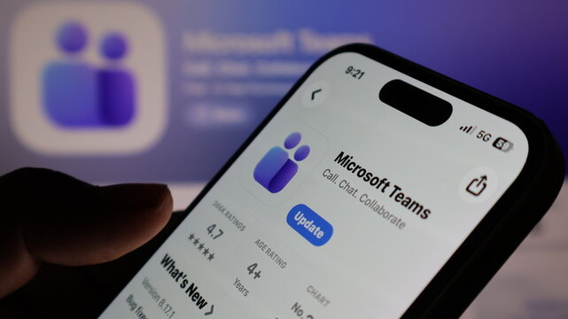 Microsoft Teams application update screen on modern smartphone with application icon in background.