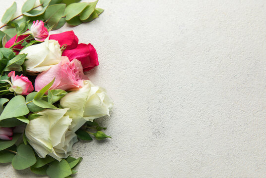 Roses bouquet with eucalyptus leaves on concrete background