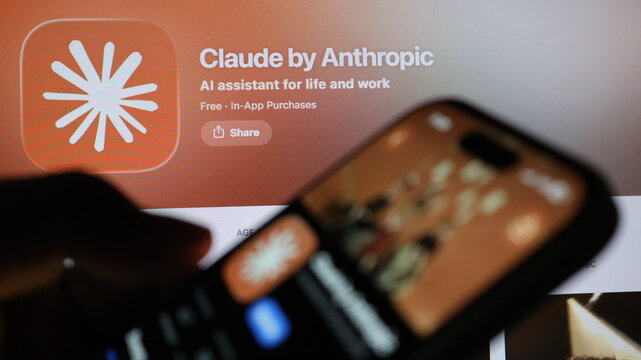 Smartphone displaying Claude by Anthropic app page on blurred background for mobile technology and artificial intelligence concept.