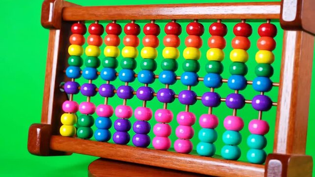 Wooden abacus with colorful counting beads rotating on green screen