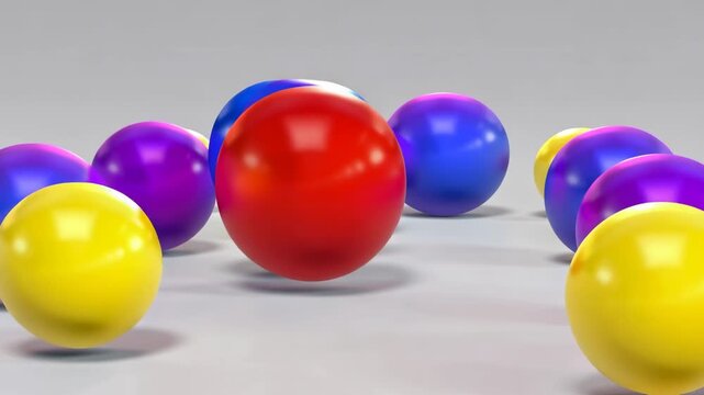 Scattered colorful spheres in motion on a clean surface with subtle lighting and depth of field effect