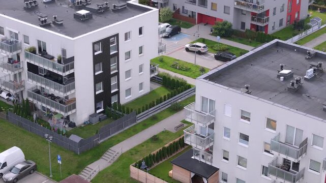 Modern apartment buildings exterior, aerial view of contemporary residential housing estate with balconies and flat roofs