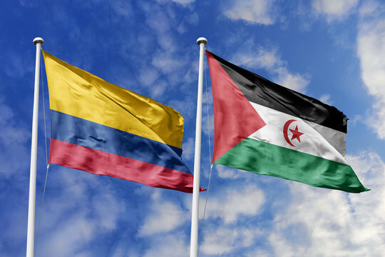 Colombia and Sahrawi Arab Democratic Republic flags waving in a clear blue sky, and a shared vision of unity for a sustainable future.