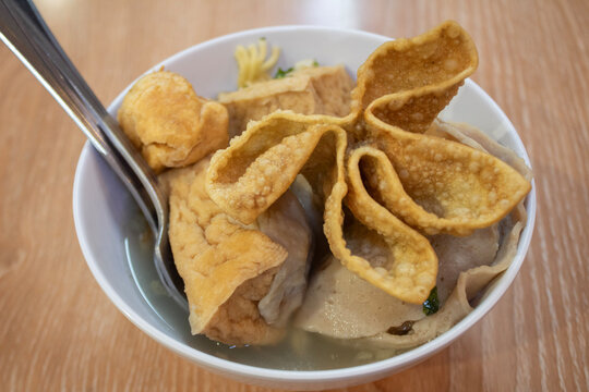 Top view of meatball soup (bakso malang). Indonesian meatballs served with fried wonton, beef meatballs, vermicelli noodles, dumplings. 
