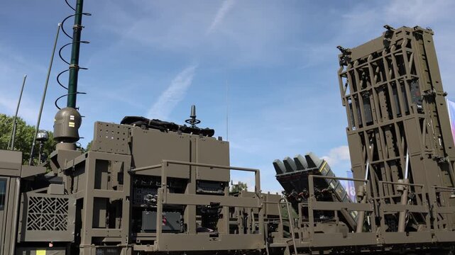 Military air defense system displays missile launch canisters radar equipment antennas and command modules mounted on a heavy tactical vehicle for field operations onsite