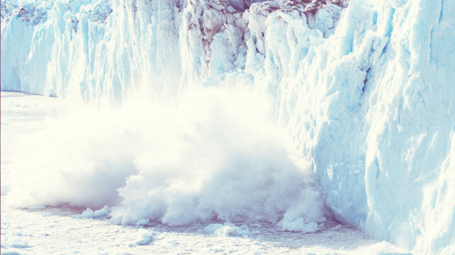 Glacier calving event creating a powerful splash as ice breaks from the massive wall into cold arctic water