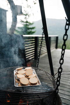 Making grilled chocolate marshmallow cookies outdoors on a deck