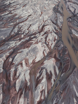 Aerial view of a braided river system with sediment patterns