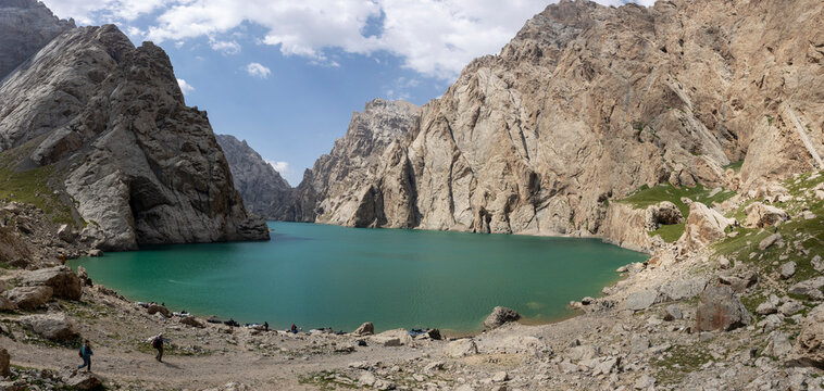 Turquoise alpine lake surrounded by dramatic rocky cliffs