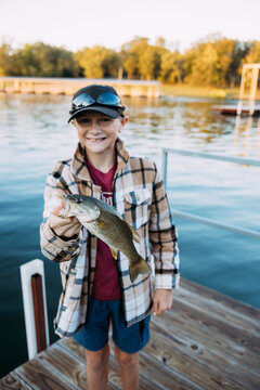 Boy Holding Up Bass Fish Caught on Table Rock Lake