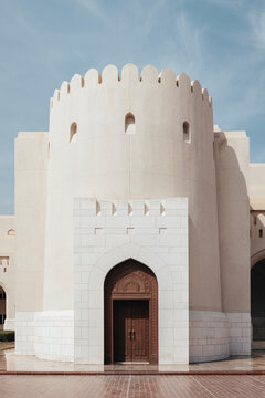 Historic Omani fort architecture with ornate wooden door