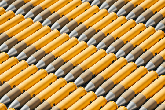 Many large caliber ammunition shells organized neatly