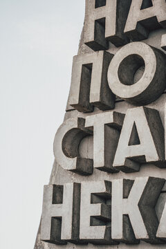 Detail of large concrete Cyrillic letters on monument