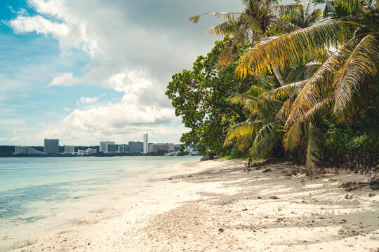 Tumon Bay skyline seen from a quiet tropical beach in Guam