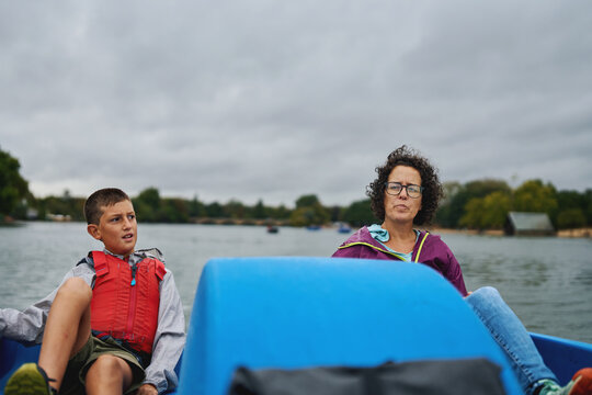 Mother and boy enjoying a boat ride on a lake