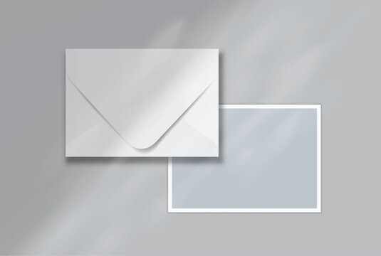 Blank postcard and envelope mockup on a soft background, featuring a minimal layout with realistic shadows for stationery branding, invitation design, wedding cards, gift card and print presentation