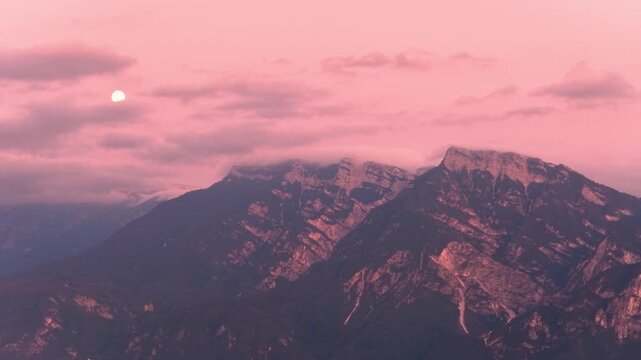 Rugged mountain massif at Mount Ortigara glowing beneath pink