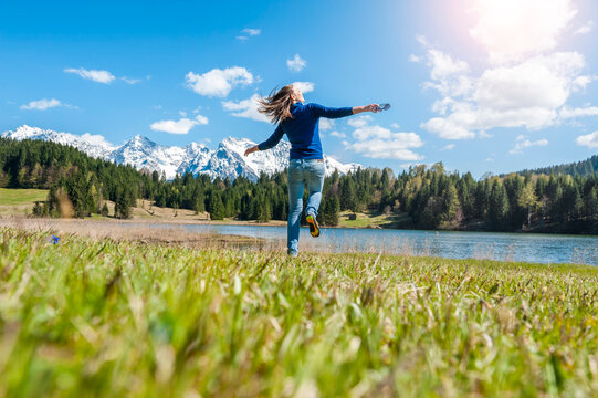 Germany, Bavaria, carefree woman at lake Barmsee
