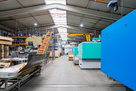 The modern production hall contains heavy machinery and equipment