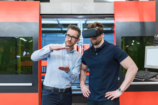 Engineer explains virtual reality simulation in production facility