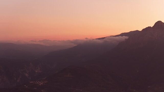 Sunset colors spread across rugged Dolomite mountain peaks