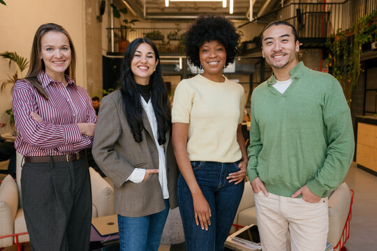 Confident business team standing in modern office environment