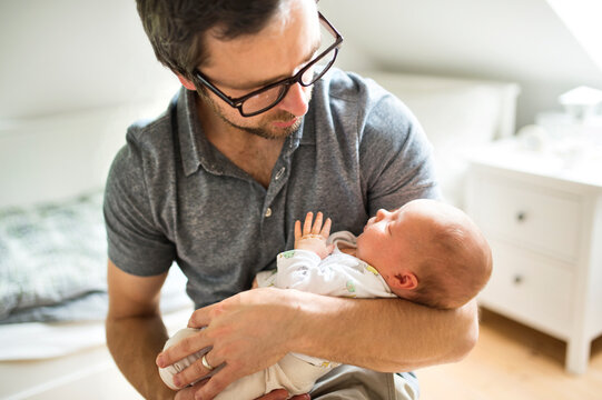 Father at home with his baby daughter