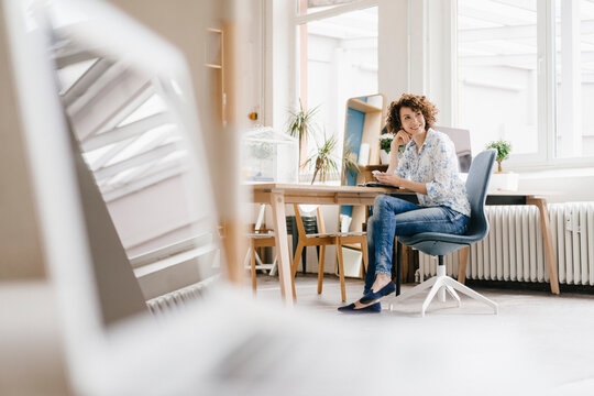 Businesswoman in office using smartphone