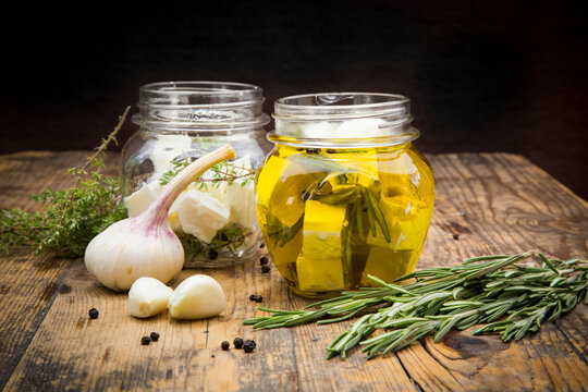 Glass of diced sheep cheese pickled in olive oil, thyme, garlic, pepper and rosmary