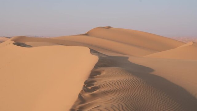 Wind carved trail across golden sand dune in Liwa Desert UAE forming abstract natural pattern and journey concept