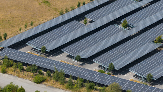Aerial view shows empty solar carport for electric vehicle charging