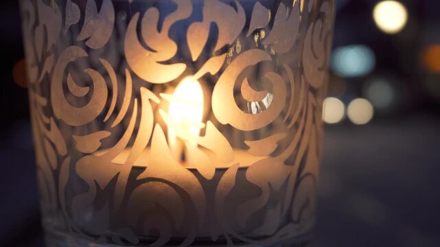 ornate candle holder glowing with warm flickering flame behind decorative floral cutouts, close up detail with soft bokeh lights in dark background