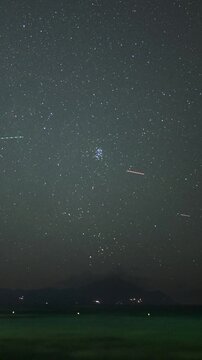 Night timelapse of the Pleiades and Aldebaran rising above Mount Athos over the Aegean Sea, Sarti, Greece