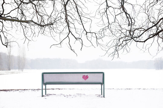 Embroidered heart at bench in winter landscape