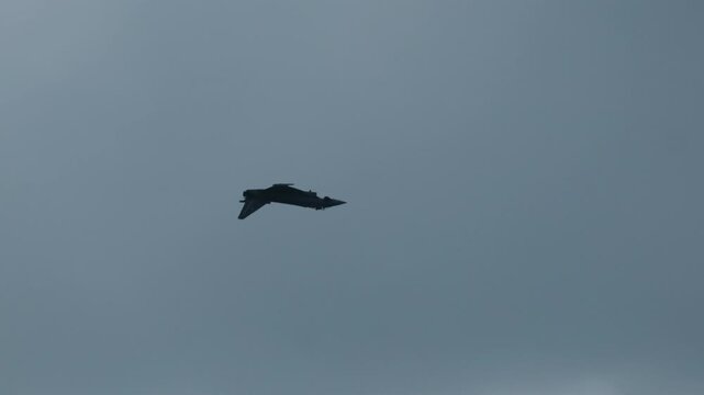 Military Eurofighter Typhoon jet performing acrobatic flight maneuvers