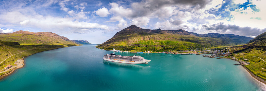Cruise ship navigates turquoise waters of Sey�isfj�r�ur Fjord