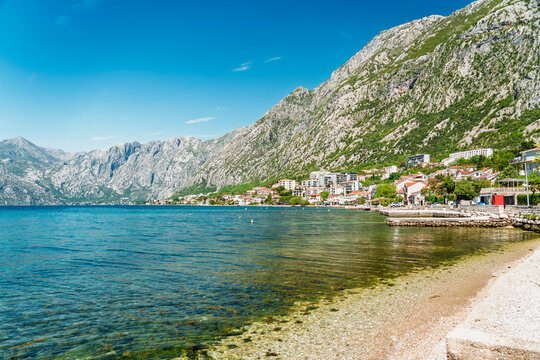 Clear water laps the beach at Dobrota in Kotor Bay Montenegro