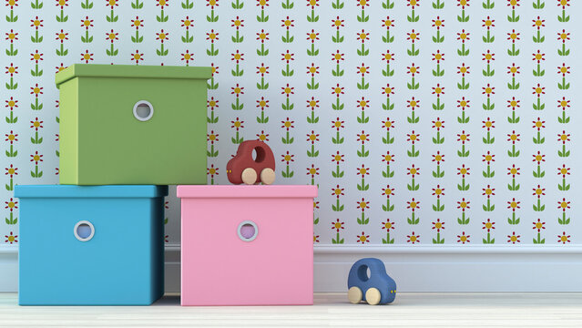 Wooden toy cars and cardboard boxes in front of wall paper with floral design