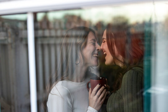 Intimate couple sharing a romantic moment indoors by a window