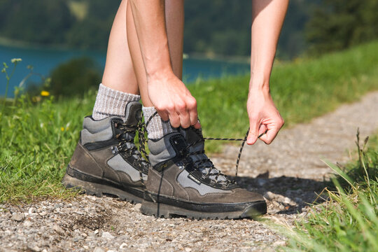 Austria, Lake Mondsee, Person tying shoe
