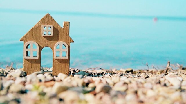 The symbol of the house standing on the seashore
