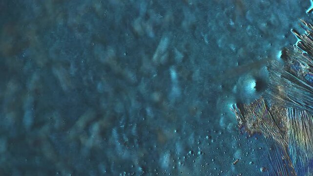 Thick crystal layer growth displaying volumetric 3d relief and metallic texture under polarized light microscope timelapse for materials science laboratory research and engineering education asset