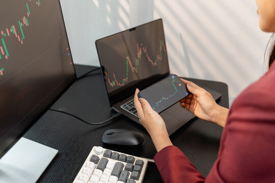 Professional investor monitoring financial markets and analyzing investment opportunities in a modern office, representing stock trading, market research, portfolio management.