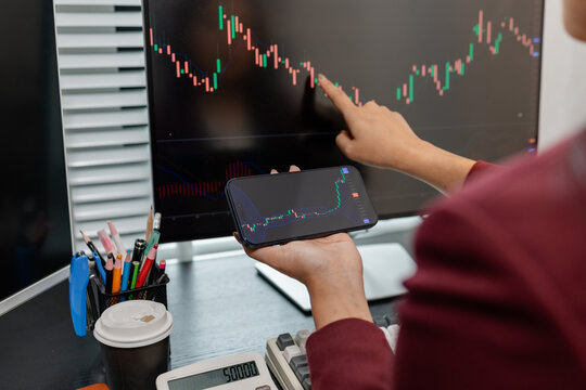 Professional investor monitoring financial markets and analyzing investment opportunities in a modern office, representing stock trading, market research, portfolio management.