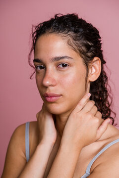 Portrait of Hispanic woman with curly hair and natural skin against