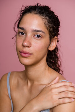 Portrait of Hispanic woman with natural skin and curly hair